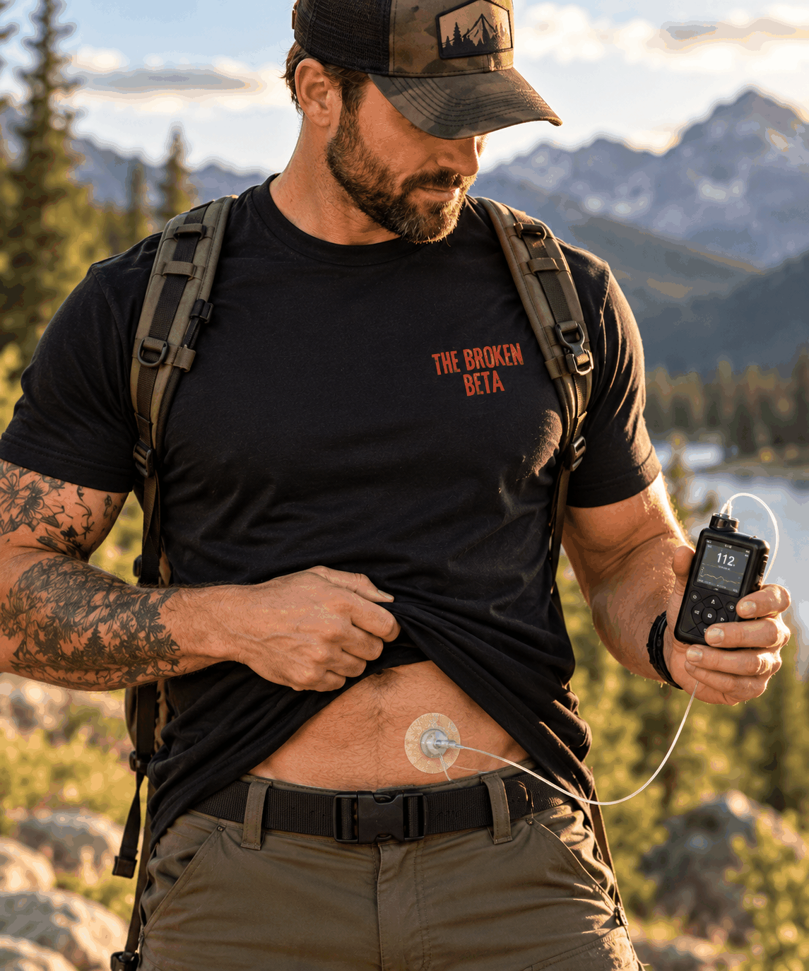 The Broken Beta T-shirt, Black tee modeled with small front logo; medical device shown as a lifestyle prop