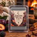 Fireside Plum Wax melt in a clear clamshell, with pale wax and a plum, berry and fireside-themed label