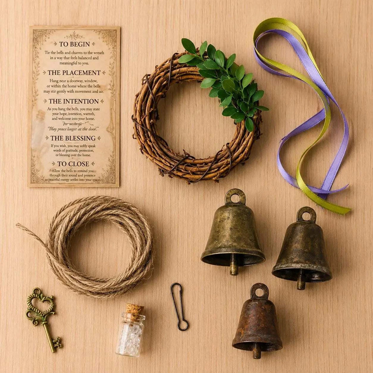 Threshiold Bells set with a brown twig wreath, three aged bronze bells, vintage-style key, clear quartz vial and cord