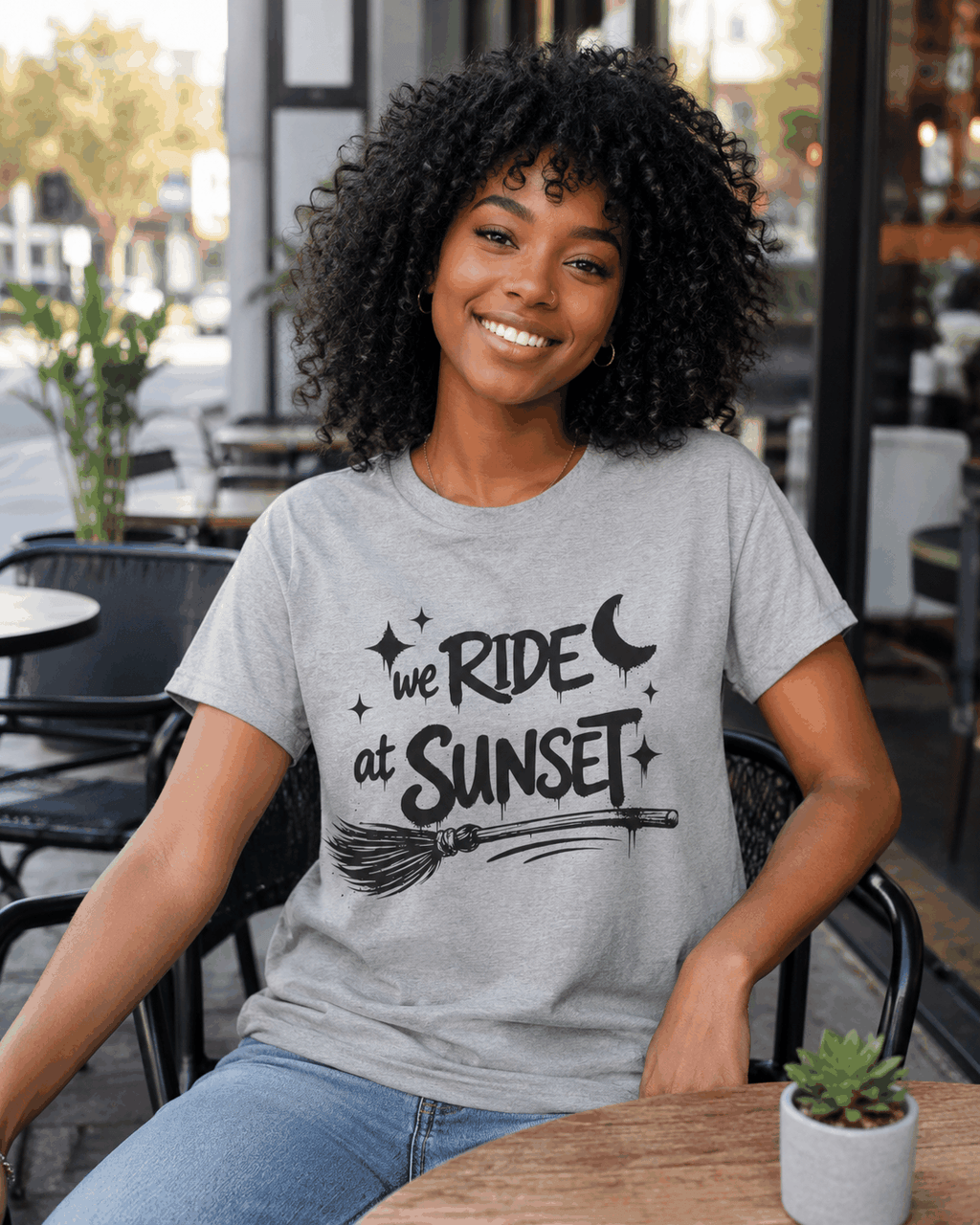 We Ride at Sunset T-shirt, Ice Grey tee modeled outdoors with moon, stars and broom graphic